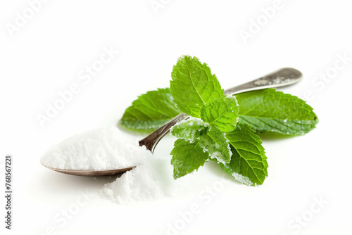 A sprig of fresh mint and a spoon of powdered sugar for garnishing a Mint Julep, isolated on a white background 