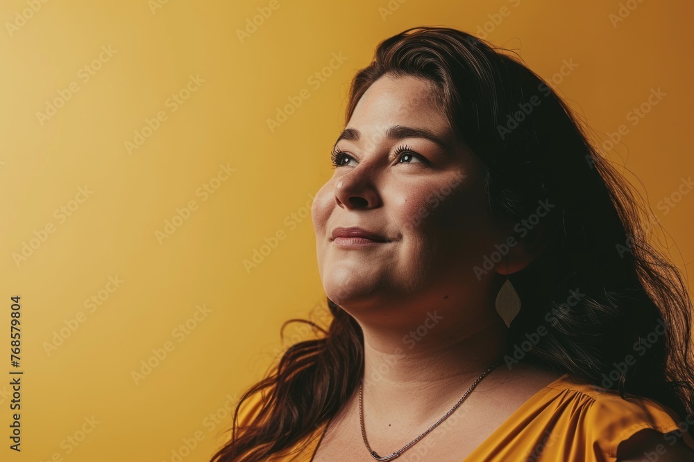 Portrait of a beautiful woman on a yellow background. Studio shot. Portrait of a beautiful woman on a yellow background. Studio shot.
