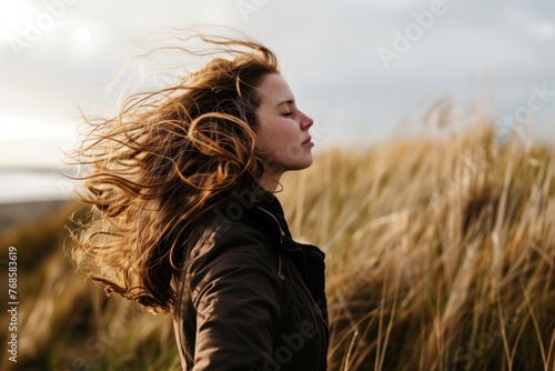 side view, woman bracing against wind