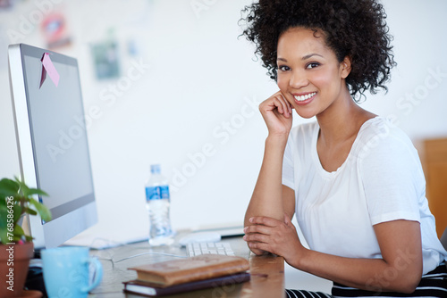 Young woman, confidence and portrait at computer for creative project, planning or copywriting career. Face of professional editor, writer or African person on desktop at creative or business startup