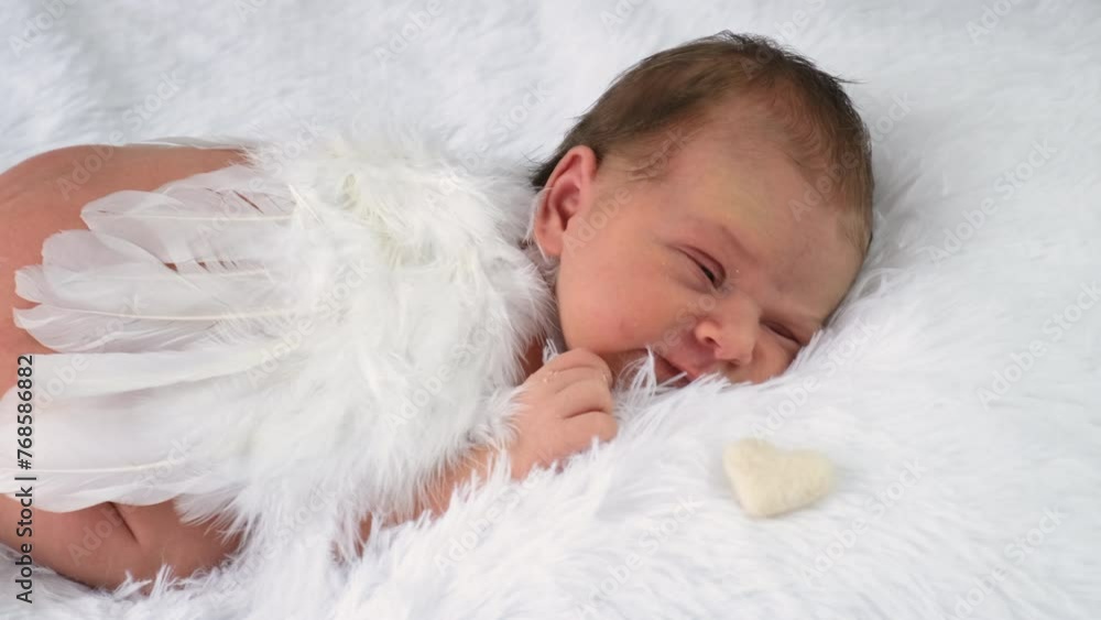 baby with angel wings sleeps on the bed. selective focus. baby with angel wings sleeps on the bed. selective focus.