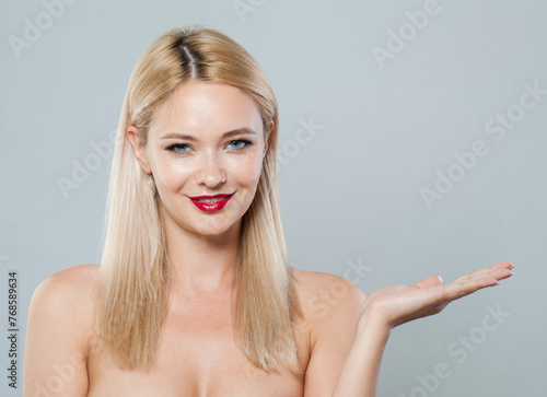 Female face and empty palm hand. Young blonde woman on white background