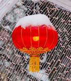 Red lanterns in the snow in the park. Chinese New Year holiday