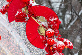 Red fans in the snow in the park. Chinese New Year holiday