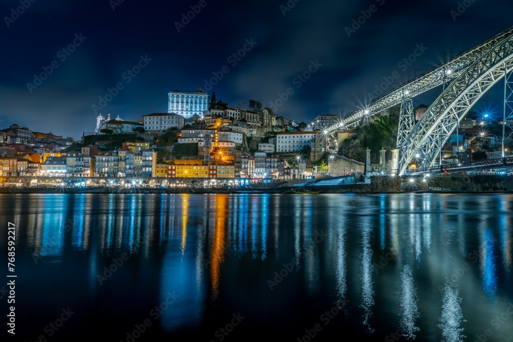 Night skyline of Porto, Portugal, on the banks of the Douro River, cityscape at night.