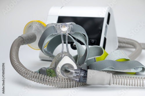 Continuous positive airway pressure system includes of CPAP machine, mask, tube on white background. photo