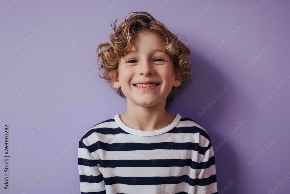 Portrait of a smiling little boy in a striped shirt on a purple background Portrait of a smiling little boy in a striped shirt on a purple background