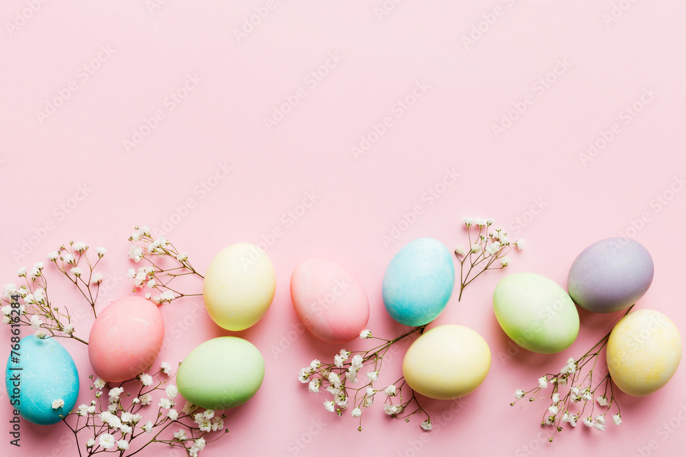 Happy Easter composition. Easter eggs on colored table with gypsophila. Natural dyed colorful eggs background top view with copy space Happy Easter composition. Easter eggs on colored table with gypsophila. Natural dyed colorful eggs background top view with copy space