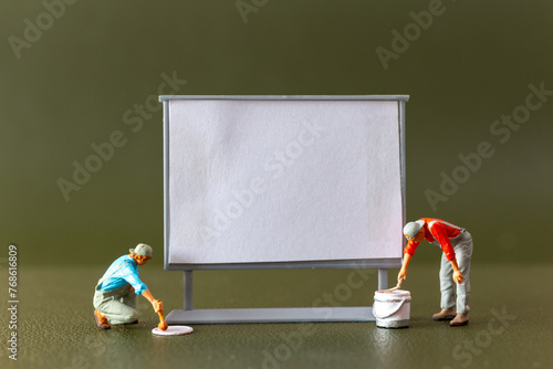 Tiny figures , A blank canvas and an imaginative artist brainstorming ideas in an art class or studio
