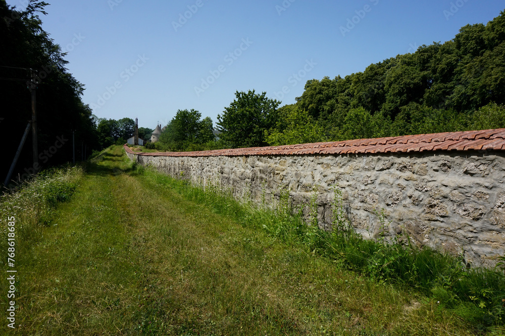 The wall of an ancient castle or monastery made of stones  