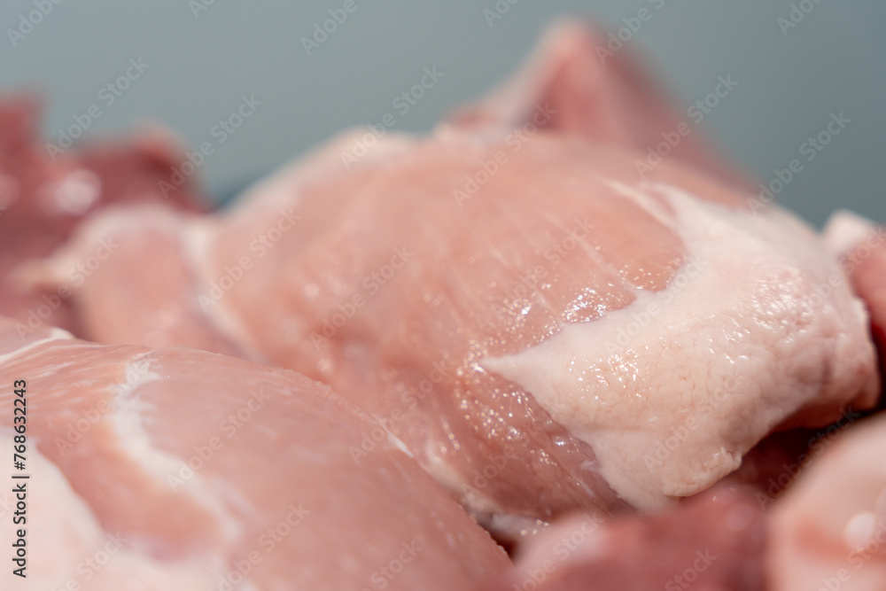 Pork meat cut into pieces lies on a cutting board. Pork meat close-up. Pork meat cut into pieces lies on a cutting board. Pork meat close-up.