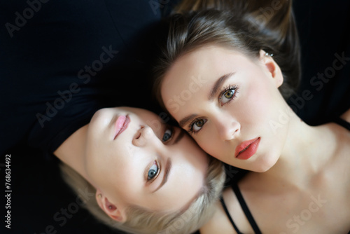 Top view of two young women on a light background.