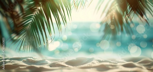 Beautiful blurred background of a sandy tropical beach and sea with palm leaves on a sunny summer day © wanna