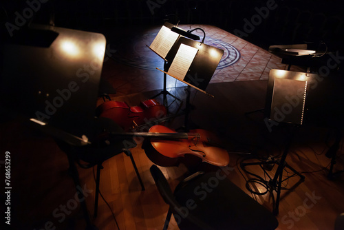 Violin and cello lie on stage before a concert
