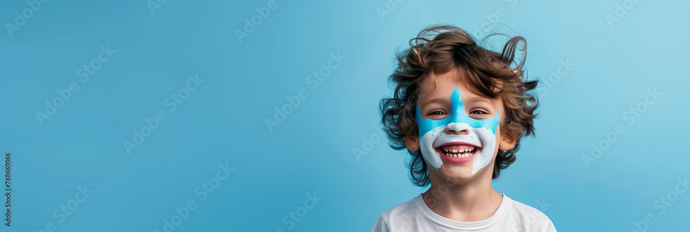 Cheerful child with shark face make-up on blue background with copy space. Cheerful child with shark face make-up on blue background with copy space.