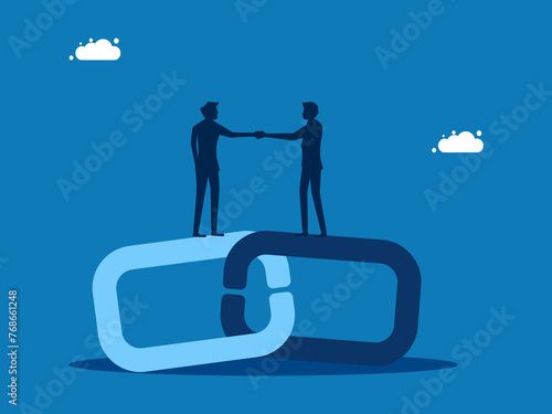 Agreed to join business. Businessmen holding hands on connecting chains