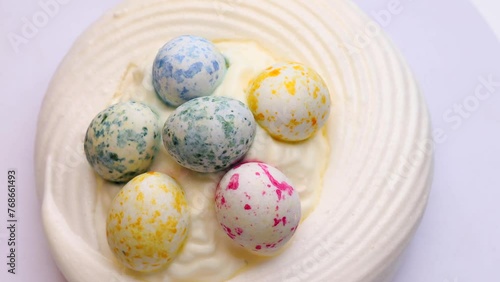 Pavlova cake, rotation in circle. Meringue beze with delicate cream and with sweet Easter Eggs, Turning. selective focus. a desert for the Easter table photo