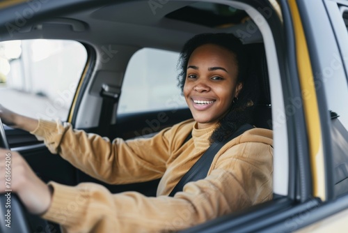 Portrait of smiling young woman driving a car