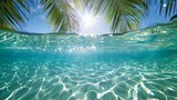 summer background with clear blue water, sun and palm trees on an exotic beach