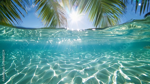 summer background with clear blue water, sun and palm trees on an exotic beach