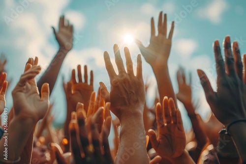A group of people are holding hands and raising their hands in the air