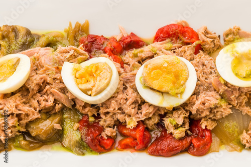 Traditional Spanish food. Roasted pepper salad with vegetables, tuna and hard-boiled eggs. top view.