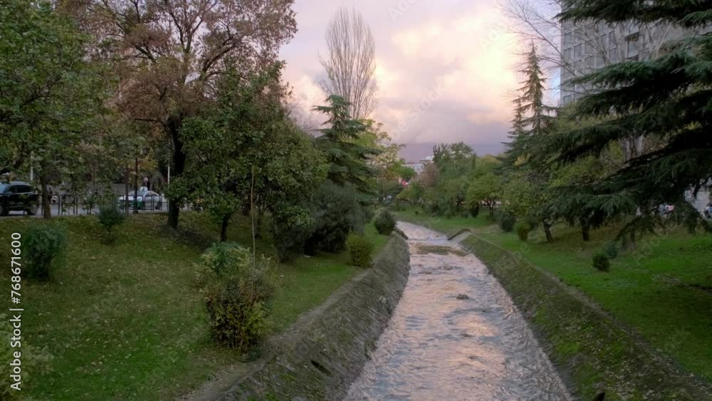 A serene flow cuts through Tirana, bringing nature's calm to urban life A serene flow cuts through Tirana, bringing nature's calm to urban life