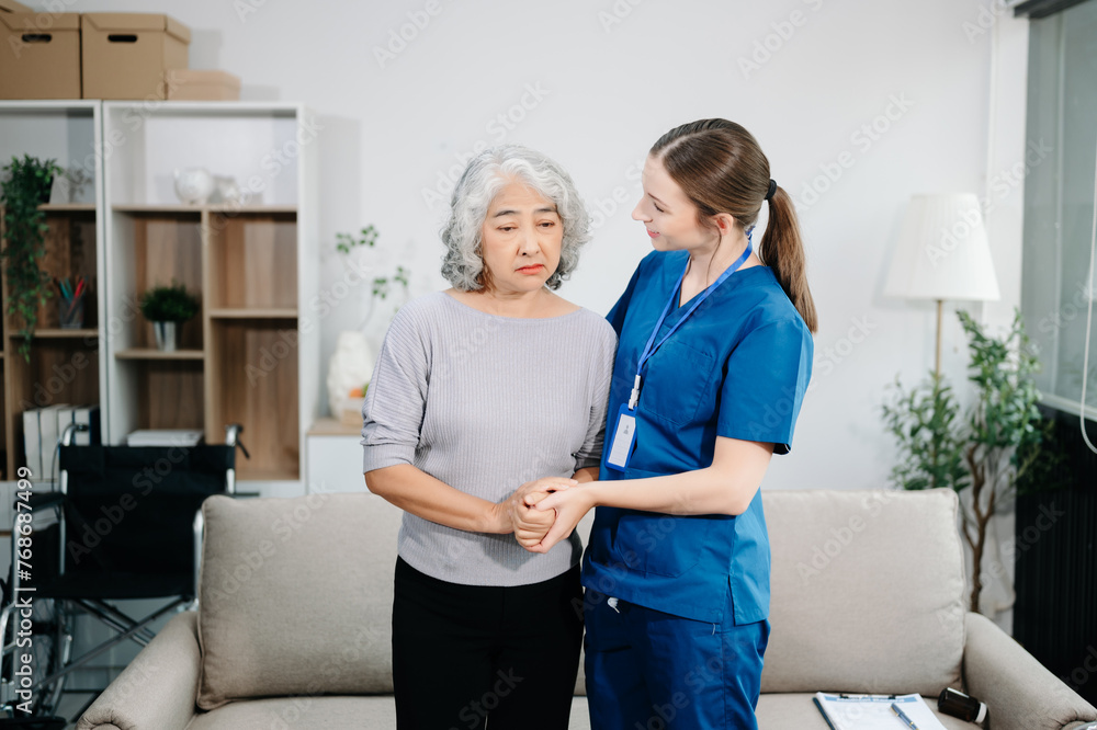 Doctors explain the use of medication to patients. Medical doctor holing senior patient's hands and comforting her on sofa Doctors explain the use of medication to patients. Medical doctor holing senior patient's hands and comforting her on sofa