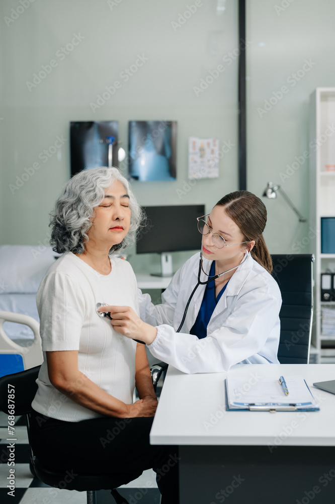 Obraz premium Doctor discussing treatment with male patient talking and laughing sitting on examination bed in clinic or hospital.