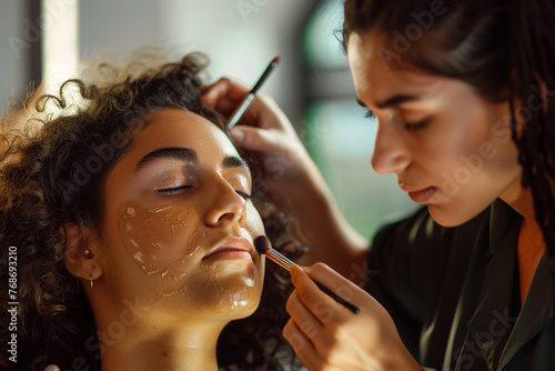 a beautiful friend doing makeup on her friend face  full ultra hd  high resolution