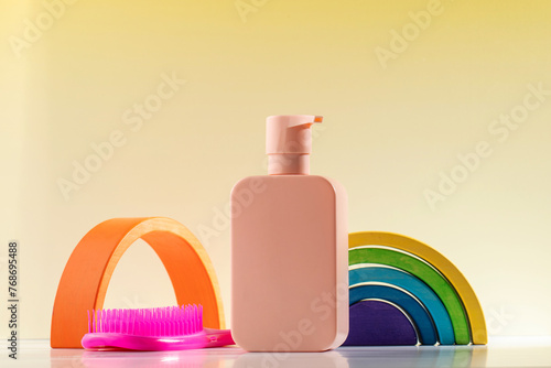 Dispenser with shower gel or shampoo for children with a comb and a toy. Skin and hair care 