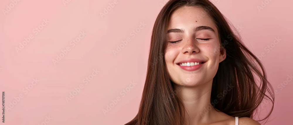 Smiling young woman with brunette long groomed hair isolated on pastel flat background with copy space for text Smiling young woman with brunette long groomed hair isolated on pastel flat background with copy space for text