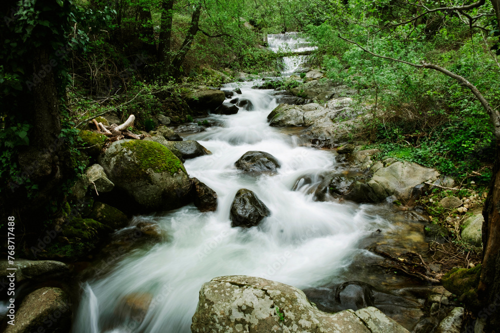 Water flows over rocks in the forest. Environmental conservation Water flows over rocks in the forest. Environmental conservation
