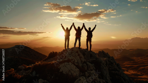 Together overcoming obstacles with three people holding hands up in the air on mountain top ,  © Edgar Martirosyan