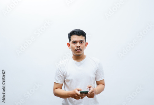 an Asian man shows a confused face while looking at his smartphone