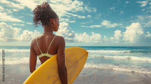 Person Standing on Beach Holding Surfboard