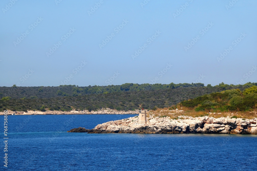 Small picturesque lighthouse on the island in the Adriatic Sea.