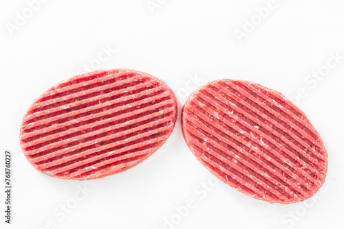 uncooked barbecue turkey patties on white
