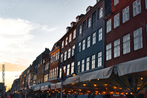 Copenhagen, Denmark - August 30, 2021. Famous Nyhavn pier with colorful buildings and boats in Copenhagen, Denmark photo