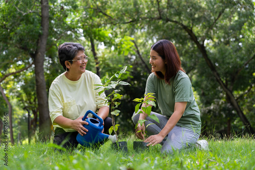 Old Asian Women and daughter join as volunteers for reforestation, earth conservation activities for reduce global warming growth feature and take care nature earth. Environment Concept