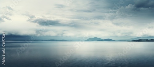 A small boat gently glides on the calm water of a lake, the sky above filled with thick, billowy clouds signaling an impending storm