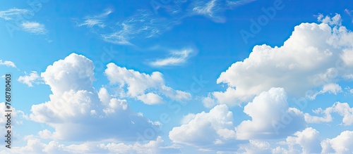 Many clouds can be seen in the sky above the water  with whispy white clouds contrasting against the bright blue sky