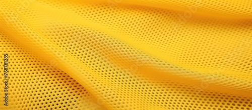 Yellow mesh sportswear fabric textile pattern background with a subtle design in a vibrant yellow shade