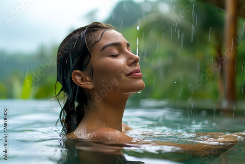 Tropical Bliss: Woman Delights in Warm Rain Shower in Infinity Pool with Jungle Views