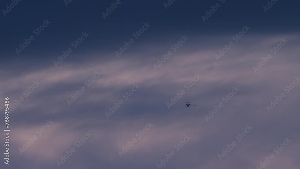 Airplane aligns with a textured cloud formation, preparing for final descent Airplane aligns with a textured cloud formation, preparing for final descent