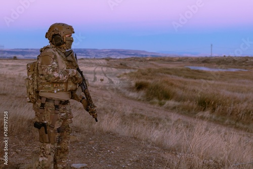 Man wearing a military uniform with a rifle © Wirestock