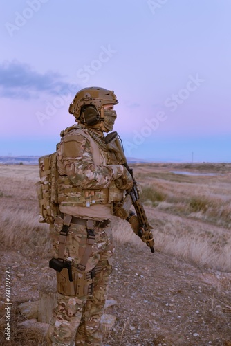 Man wearing a military uniform with a rifle