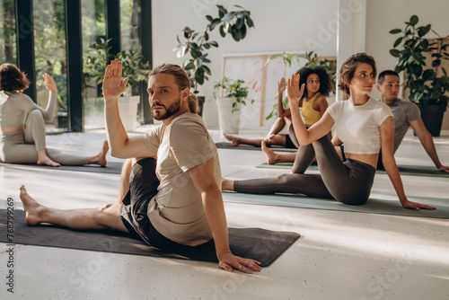 Diverse sporty people having yoga practice with instructor
