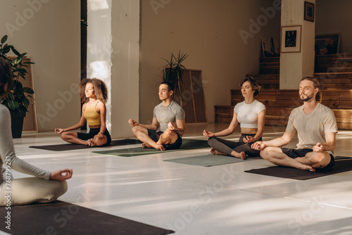 Four participants trying yoga practice with instructor