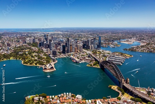 an aerial view of sydney with the harbor and city centre in the distance photo